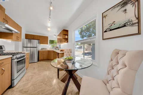 a living room with furniture a rug and white walls