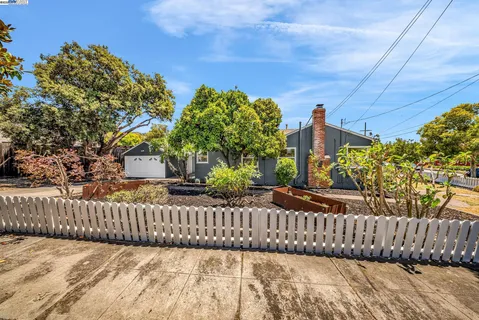 a view of a house with wooden fence