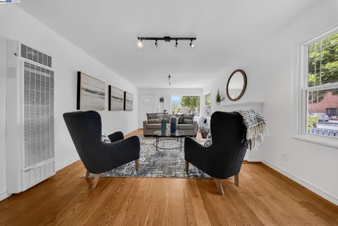 a living room with furniture a fireplace and a window