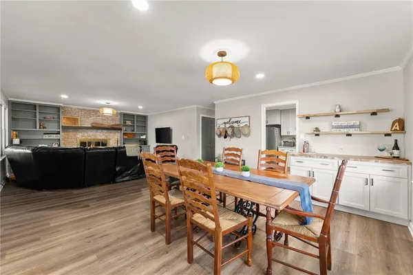 a view of a dining room with furniture and wooden floor