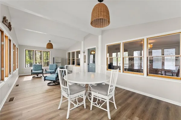 a view of a dining room with furniture wooden floor and chandelier