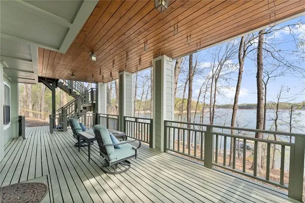 a kitchen with stainless steel appliances granite countertop a stove top oven a refrigerator a sink and dishwasher with wooden floor