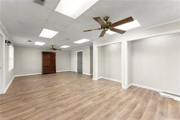 a spacious bedroom with a bed and a chandelier