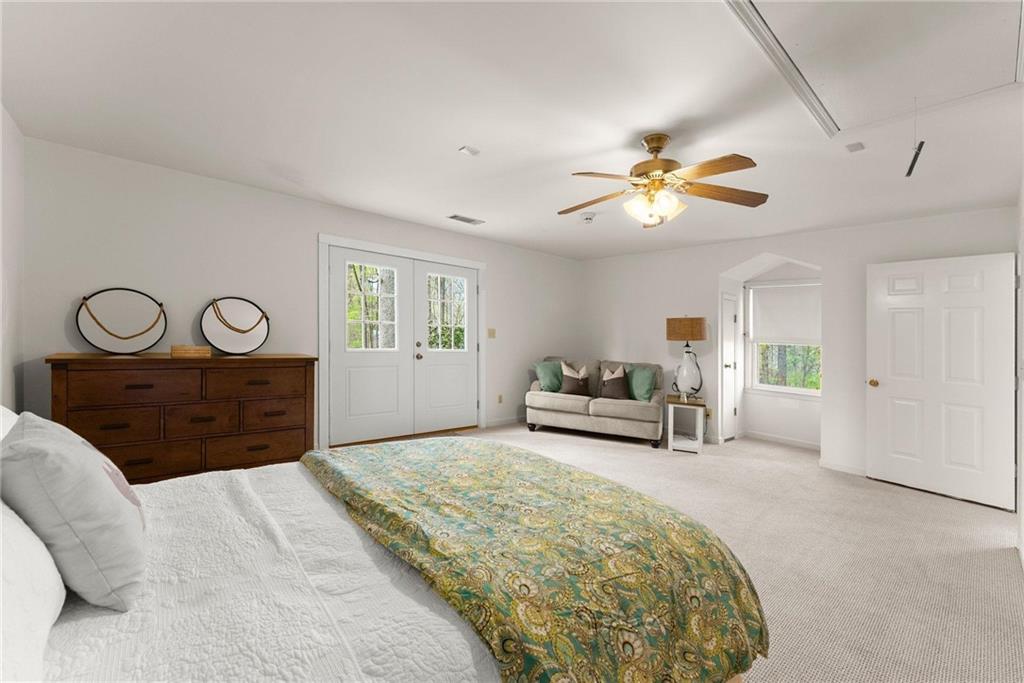 103 Tugalo Point Lavonia, GA 30553 - Photo 47 of 70 a spacious bedroom with a bed and a chandelier