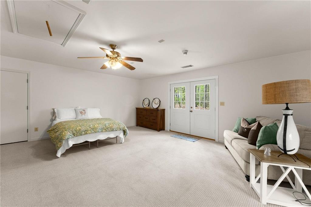 103 Tugalo Point Lavonia, GA 30553 - Photo 48 of 70 a spacious bedroom with a bed and a chandelier