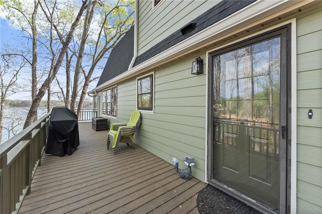 103 Tugalo Point Lavonia, GA 30553 - Photo 6 of 70 a view of a balcony with chairs and wooden floor