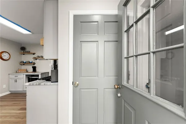 a kitchen with white cabinets and white appliances
