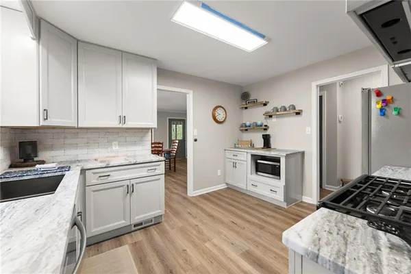 a kitchen with a stove a sink and a refrigerator