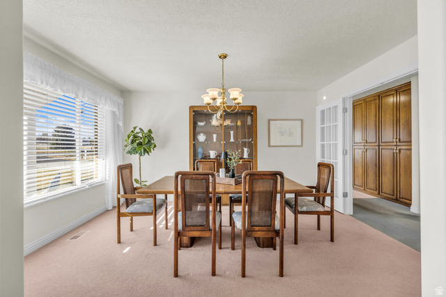 1060 West 2620th Street South Mapleton, UT 84664 - Photo 12 of 87 Dining room with suspended lighting, light colored carpet, and a textured ceiling