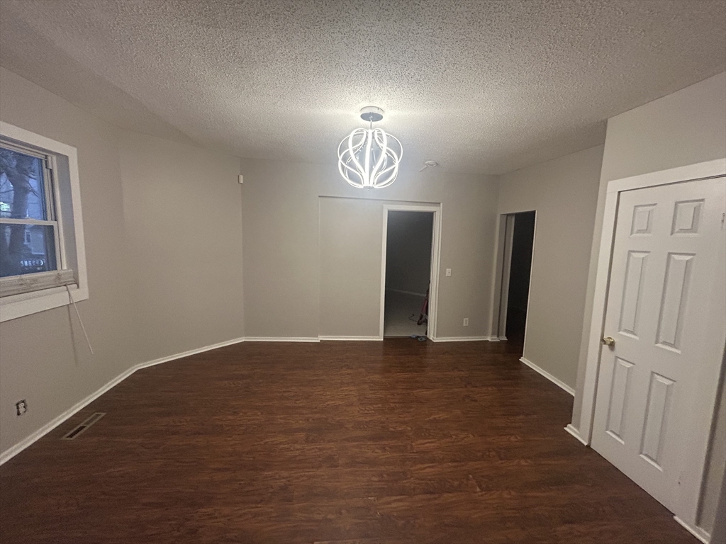62 Washburn Street Springfield, MA 01107 - Photo 4 of 16 an empty room with closet and windows