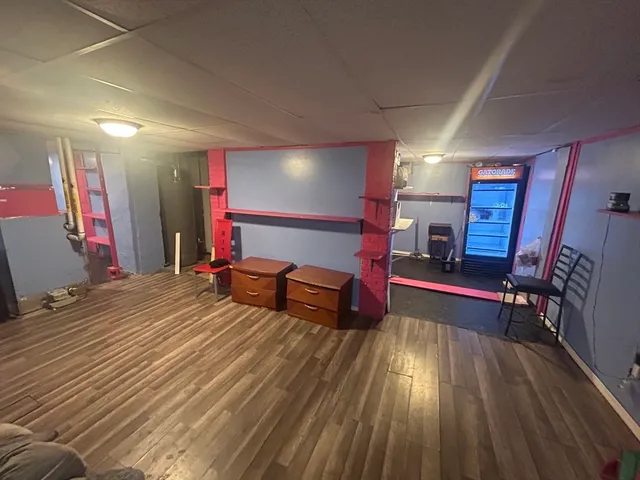 a bedroom with furniture and a wooden floor