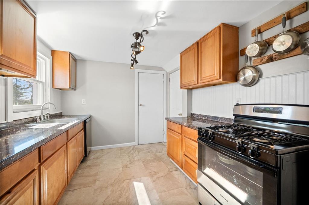 4030 Lebanon Church Road West Mifflin, PA 15122 - Photo 15 of 45 a kitchen with stainless steel appliances granite countertop a stove and a sink