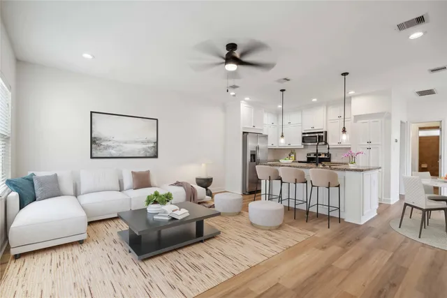 a living room with furniture and a wooden floor