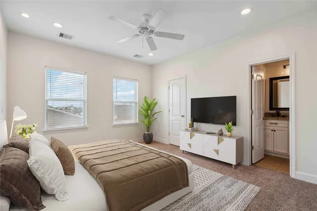 a bedroom with a bed and a flat screen tv