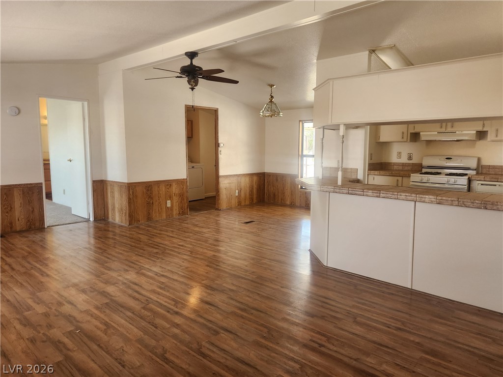 3189 Del Monte Street Laughlin, NV 89029 - Photo 32 of 32 An open floorplan seamlessly connects the living area with a functional kitchen, boasting durable tile counters and a freestanding range.