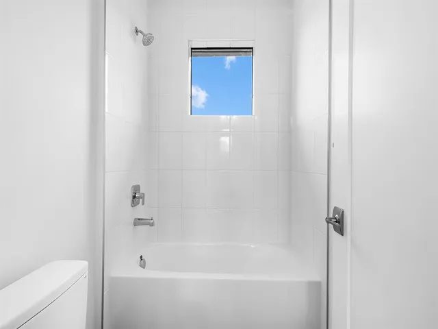 a bathroom with a sink toilet vanity and shower