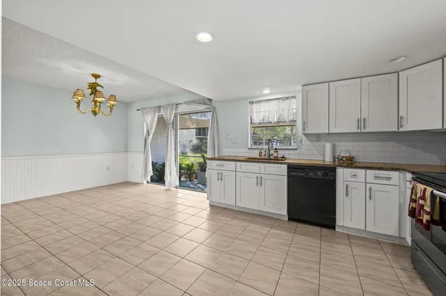 a kitchen with a sink window and cabinets