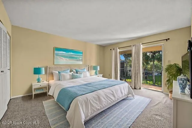 a bedroom with a large bed and a large window