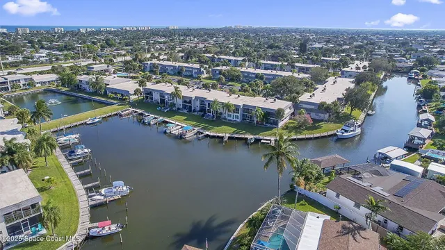 an aerial view of residential houses with outdoor space and lake view