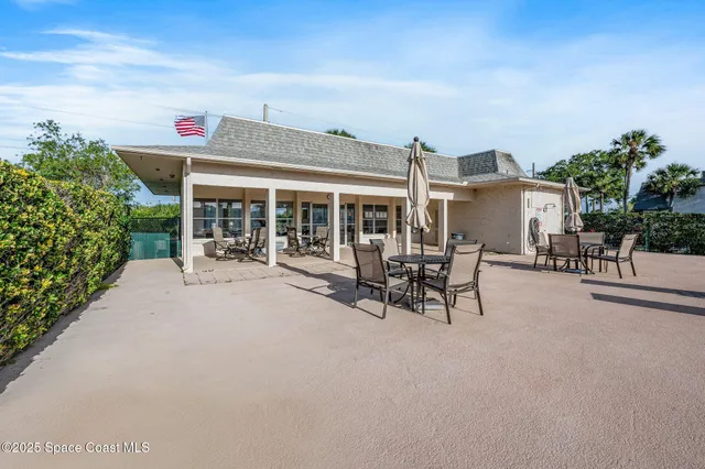 a view of a patio with table and chairs and potted plants