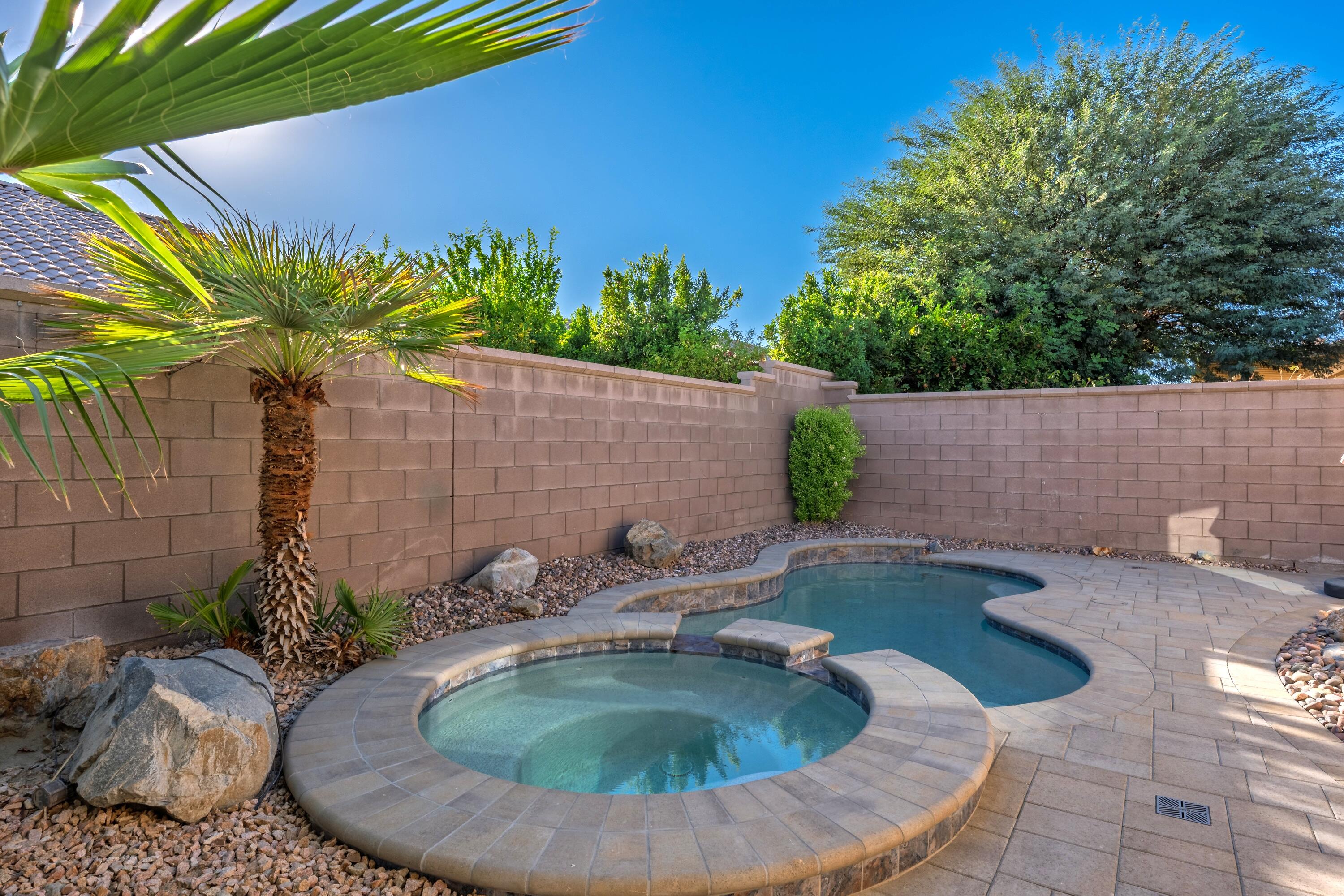 78589 Rainswept Way Palm Desert, CA 92211 - Photo 2 of 30 swimming pool view with a garden space