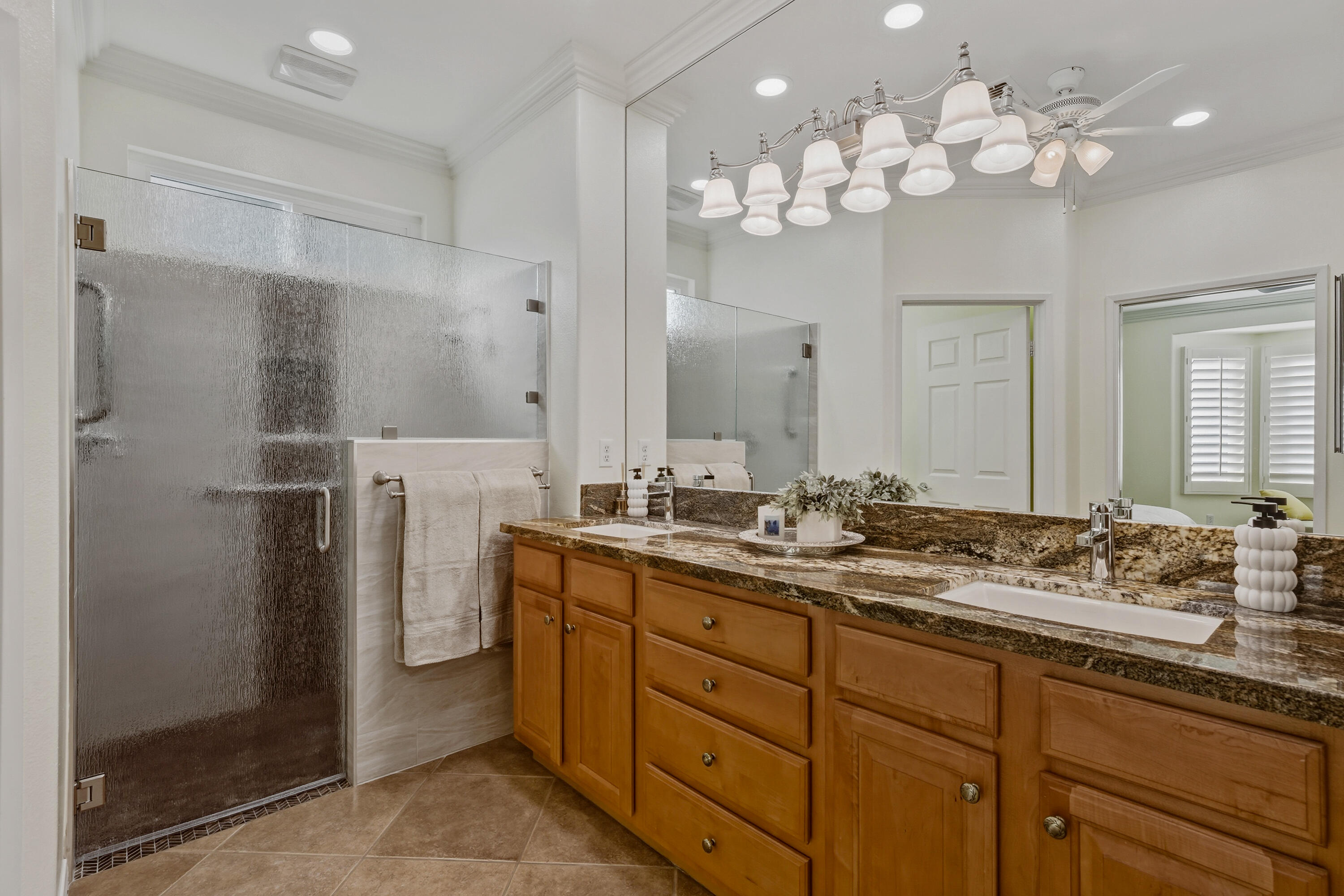 78589 Rainswept Way Palm Desert, CA 92211 - Photo 24 of 30 a bathroom with a double vanity sink mirror and shower
