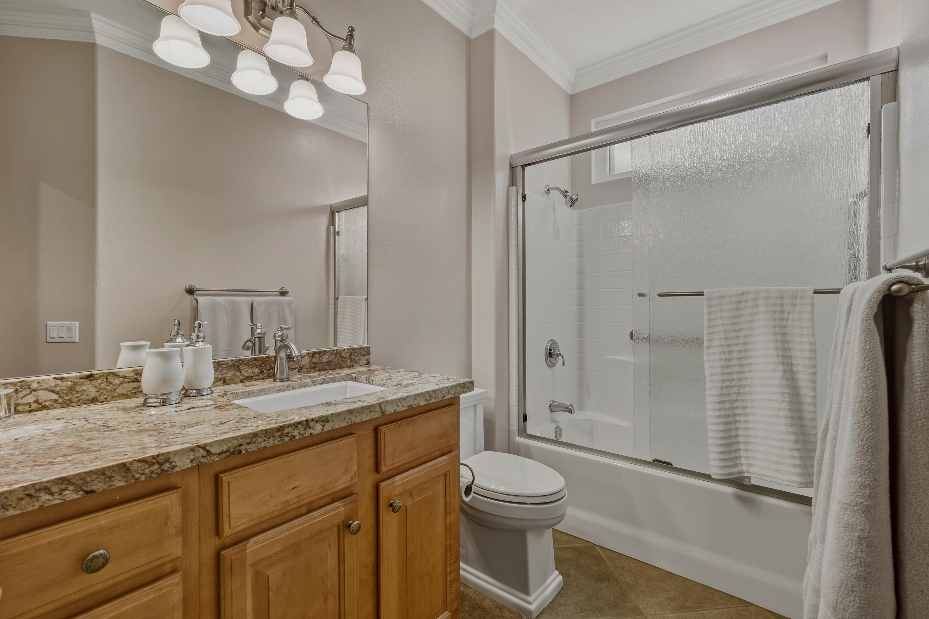 78589 Rainswept Way Palm Desert, CA 92211 - Photo 26 of 30 a bathroom with a granite countertop sink a toilet and shower