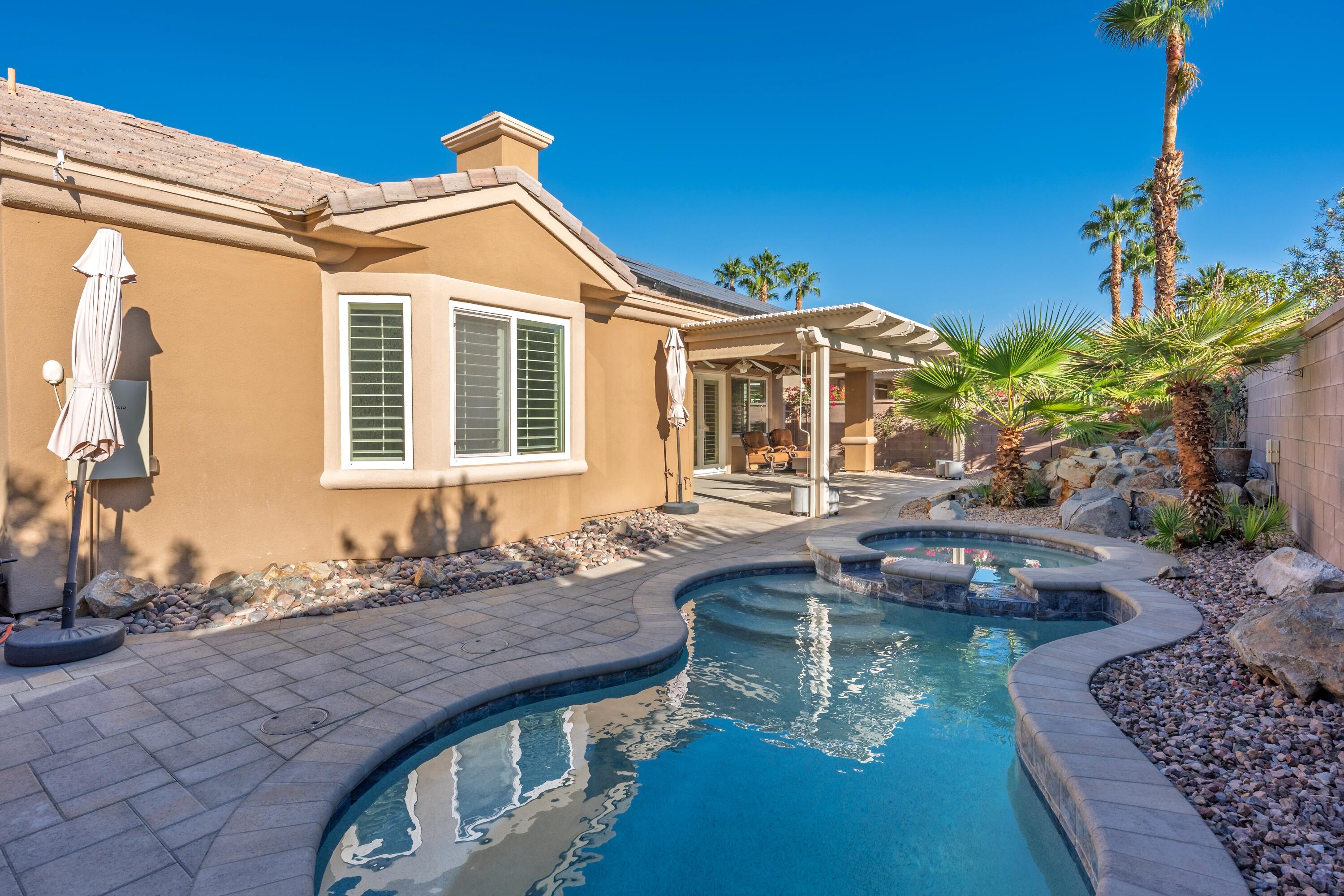 78589 Rainswept Way Palm Desert, CA 92211 - Photo 6 of 30 a front view of a house with swimming pool