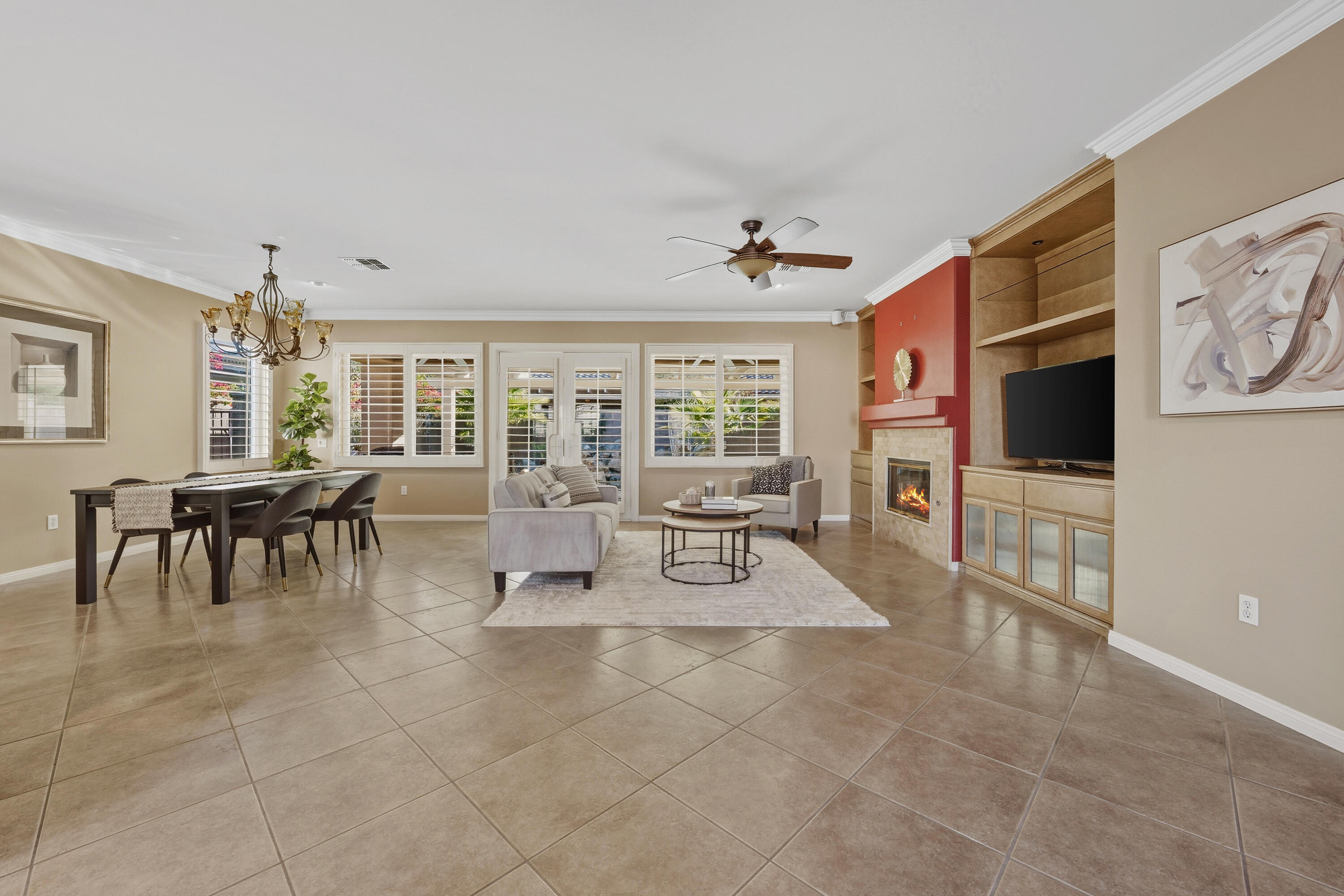 78589 Rainswept Way Palm Desert, CA 92211 - Photo 8 of 30 a living room with furniture a dining table and a flat screen tv