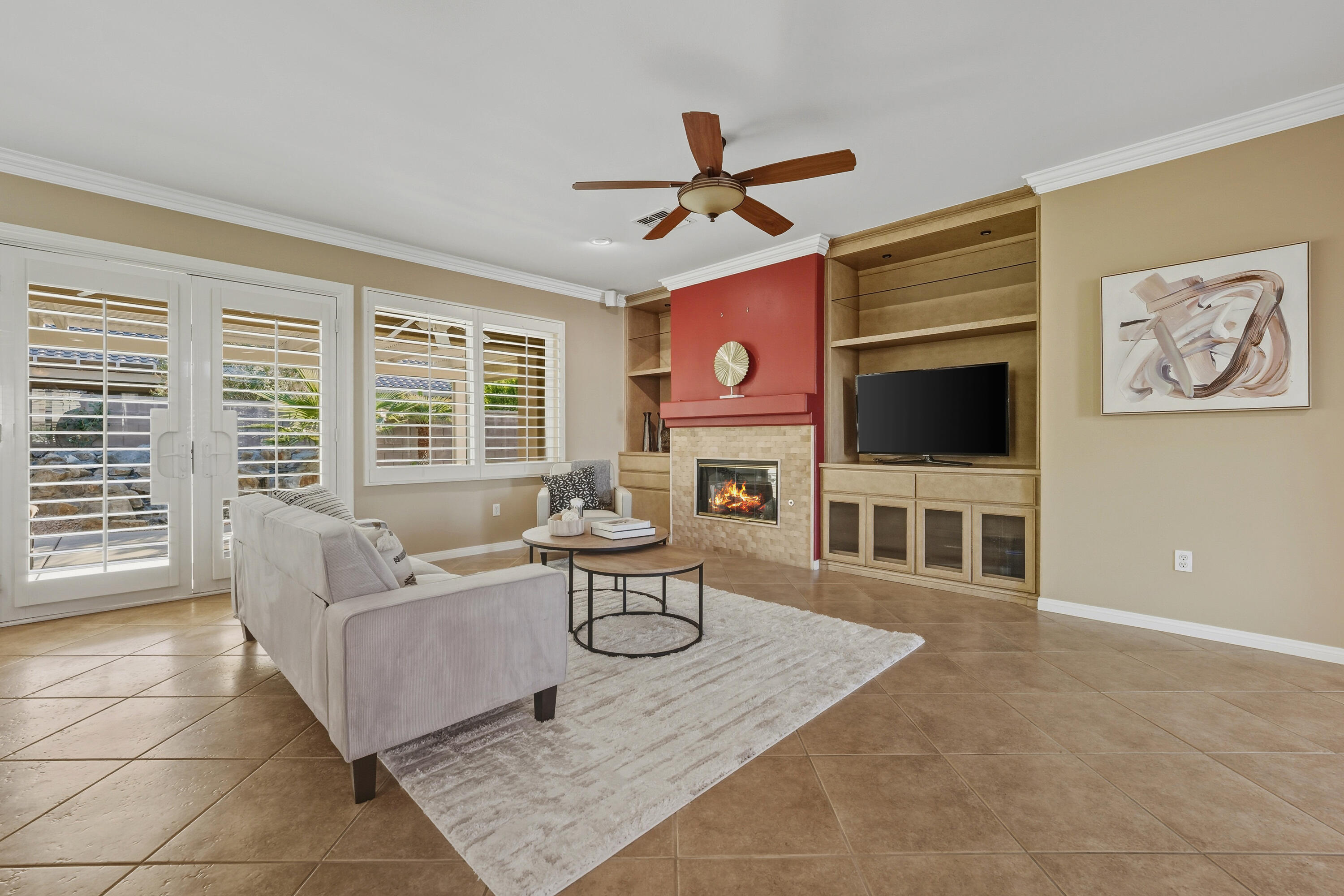 78589 Rainswept Way Palm Desert, CA 92211 - Photo 10 of 30 a living room with furniture a flat screen tv and a large window