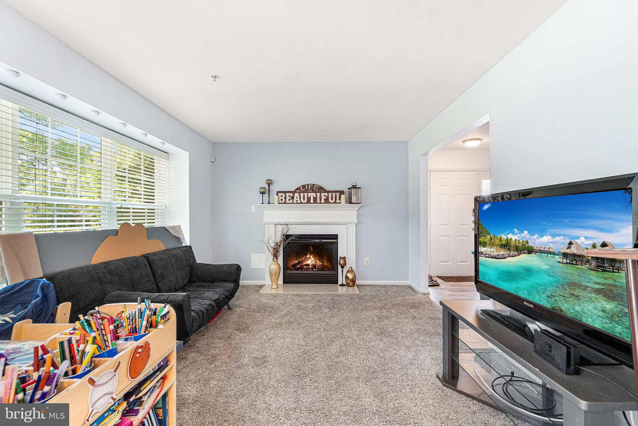 803 Tanglewood Drive Sicklerville, NJ 08081 - Photo 13 of 26 a living room with furniture a flat screen tv and a fireplace