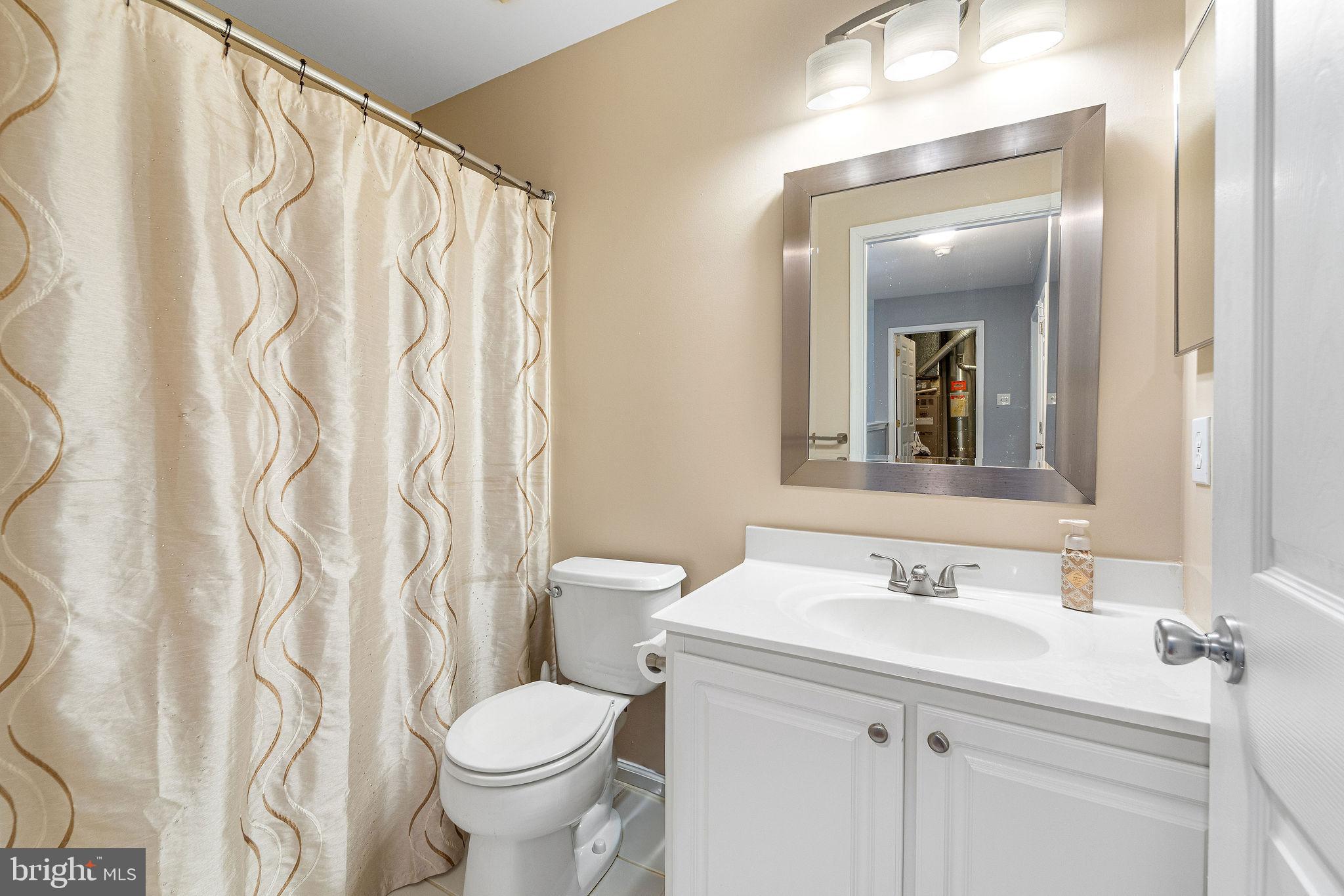803 Tanglewood Drive Sicklerville, NJ 08081 - Photo 15 of 26 a bathroom with a sink and a mirror