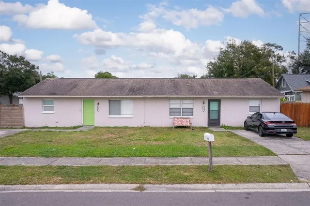 a front view of a house with a garden and garage