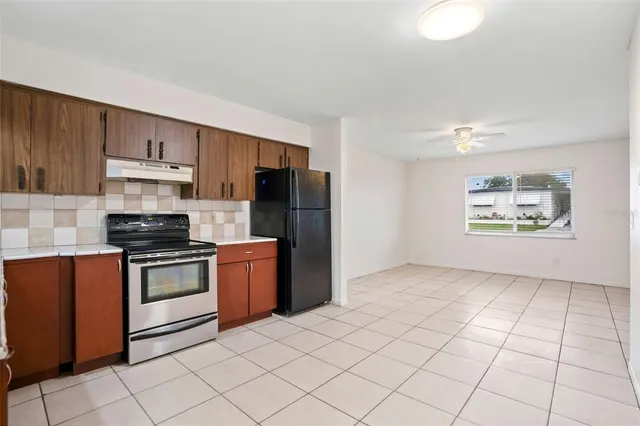 a kitchen with stainless steel appliances granite countertop a stove a refrigerator and a cabinets