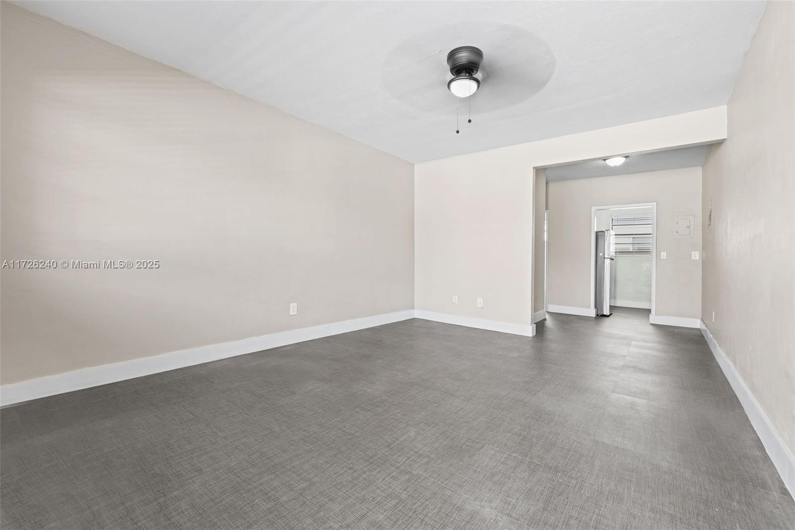 an empty room with a empty space and windows