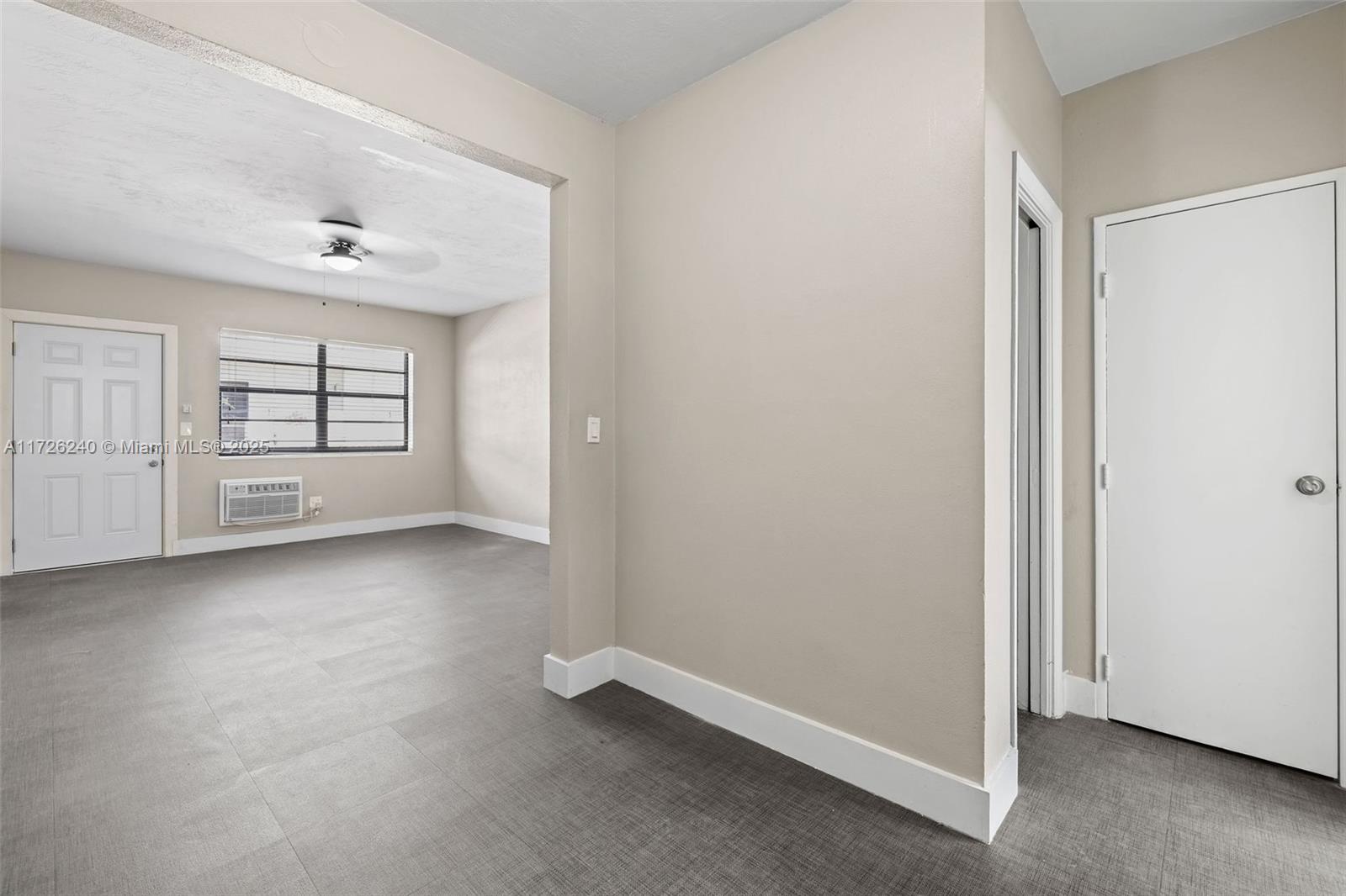 7745 Harding Avenue, Unit 22 Miami Beach, FL 33141 - Photo 5 of 9 an empty room with windows