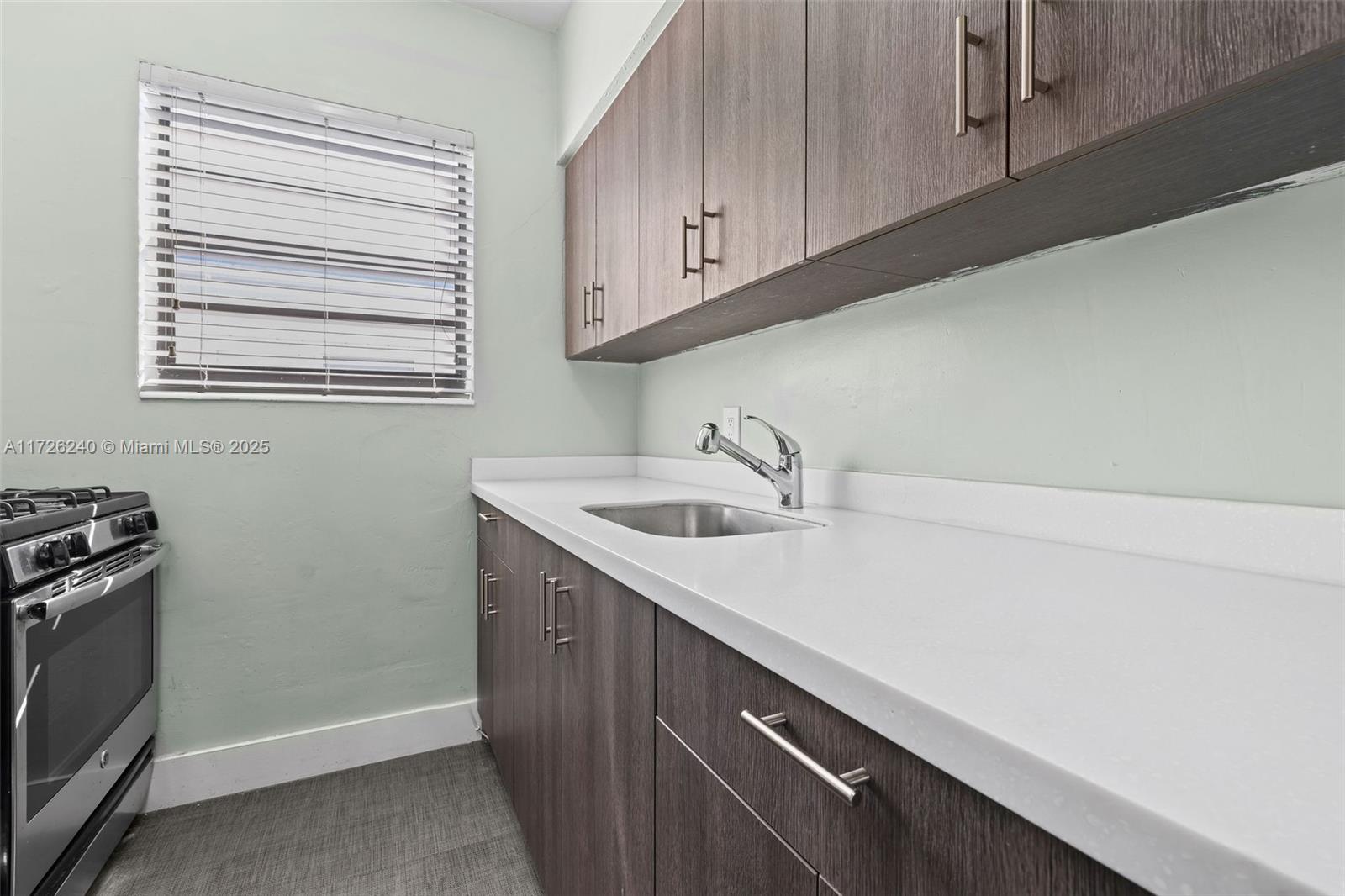 7745 Harding Avenue, Unit 22 Miami Beach, FL 33141 - Photo 7 of 9 a kitchen with a sink cabinets and appliances