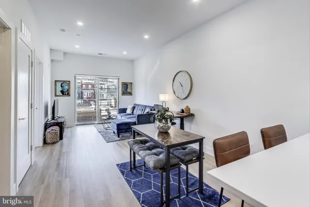 a living room with lots of furniture and a large window