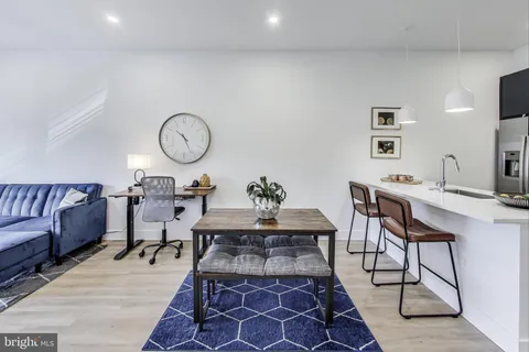 a living room with a couch and a chandelier