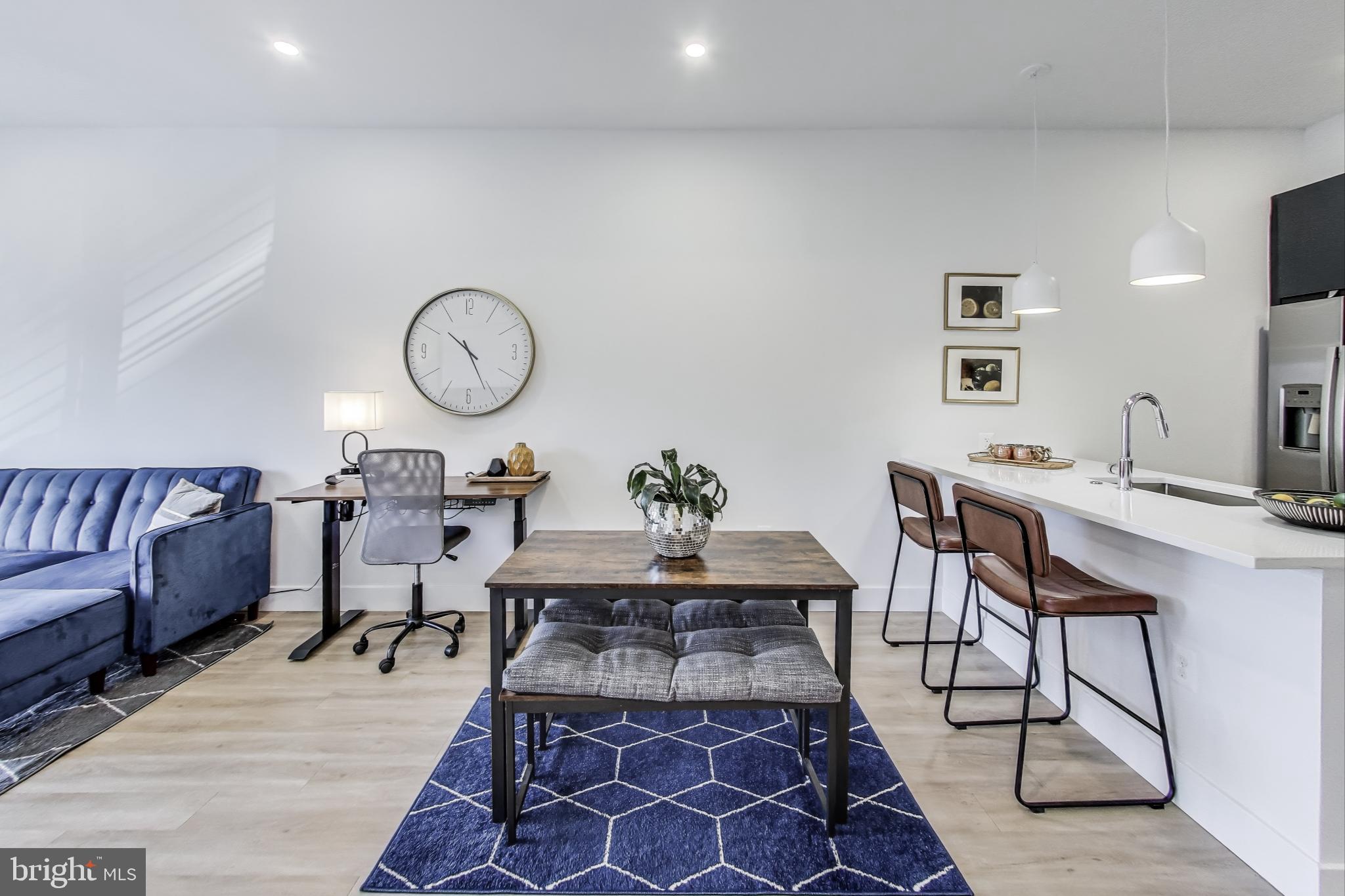 2310 4th Street Northeast, Unit 15 Washington, DC 20002 - Photo 7 of 21 a living room with a couch and a chandelier