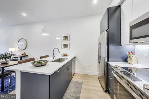 a kitchen with sink a stove and refrigerator