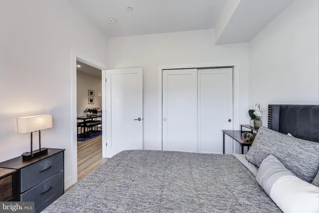 a bedroom with a bed and a lamp on table