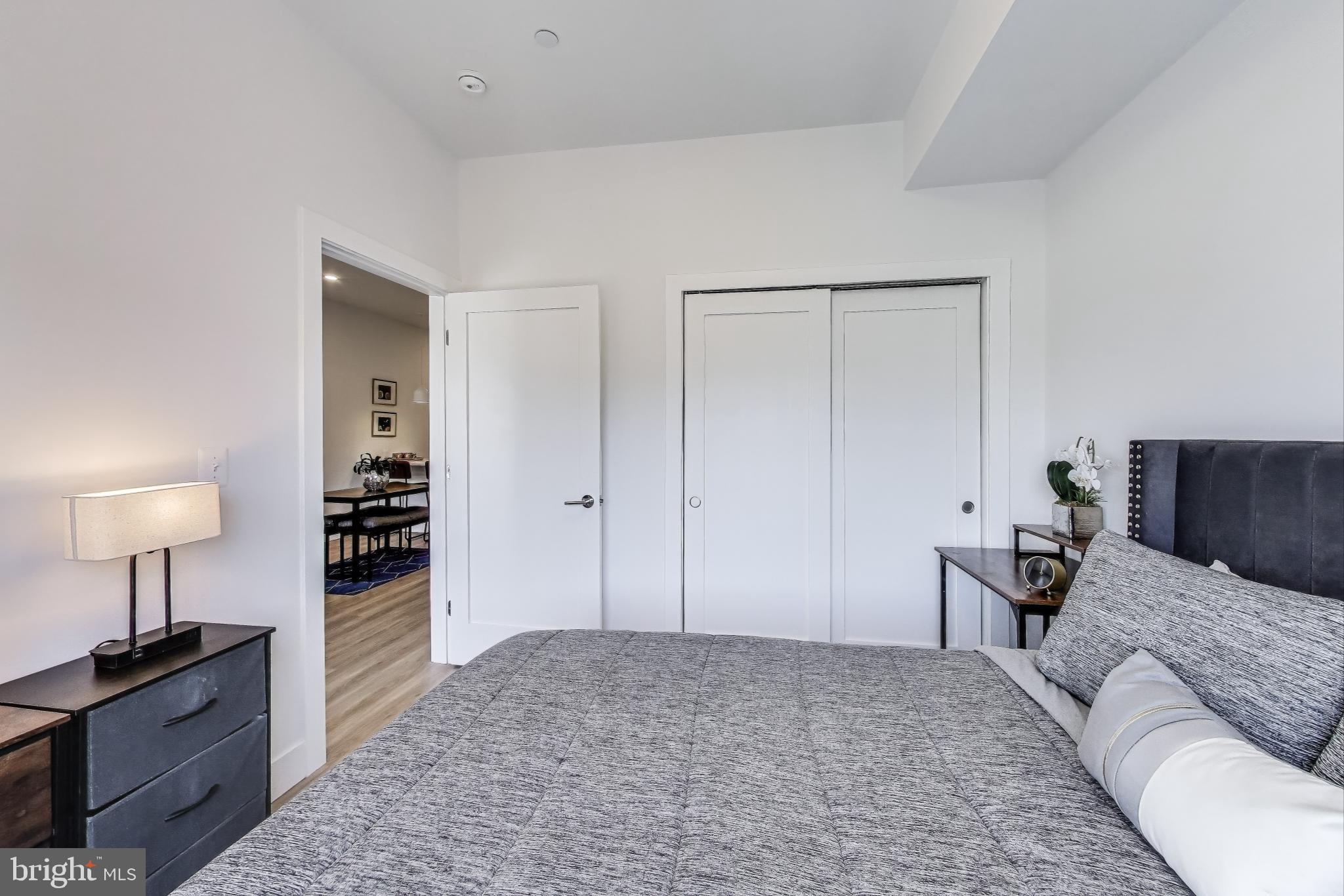 2310 4th Street Northeast, Unit 15 Washington, DC 20002 - Photo 10 of 21 a bedroom with a bed and a lamp on table