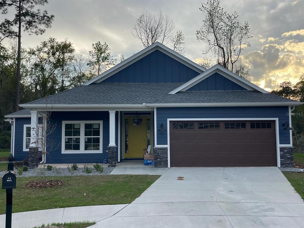 4102 Northwest 26th Drive Gainesville, FL 32605 - Photo 1 of 11 a front view of a house with a yard and garage