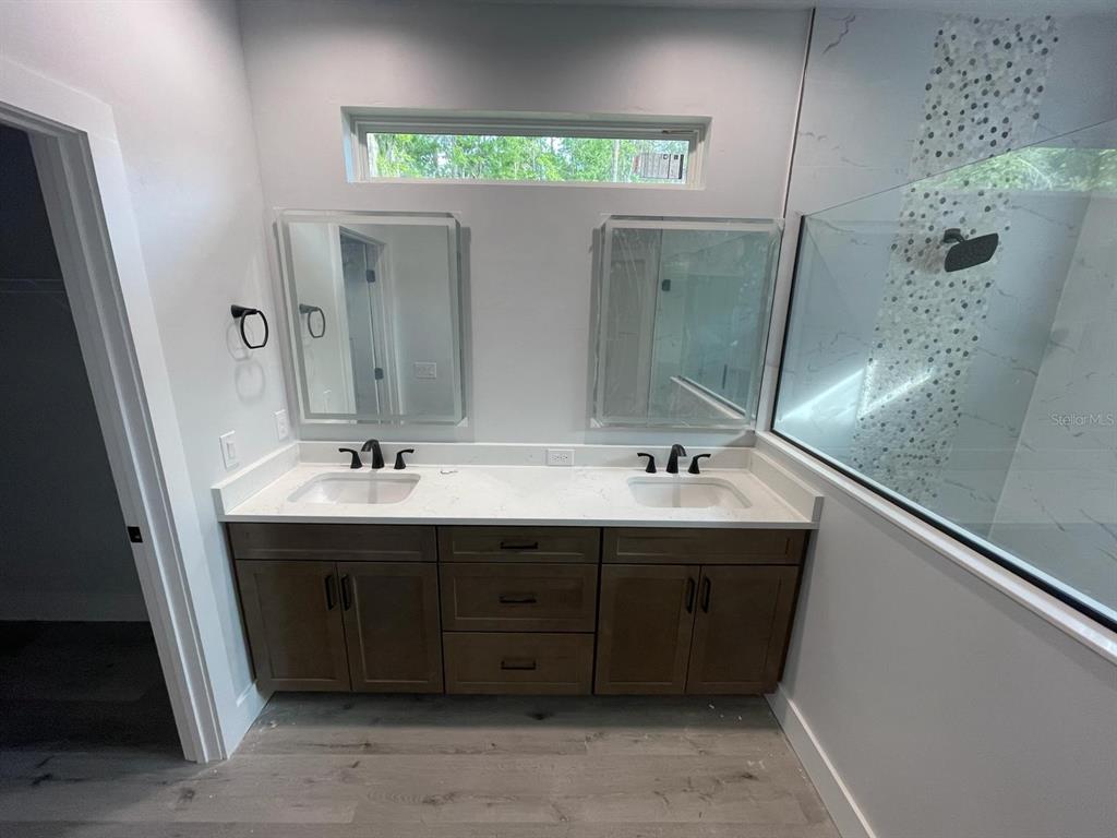 4102 Northwest 26th Drive Gainesville, FL 32605 - Photo 11 of 11 a bathroom with a double vanity sink and a mirror