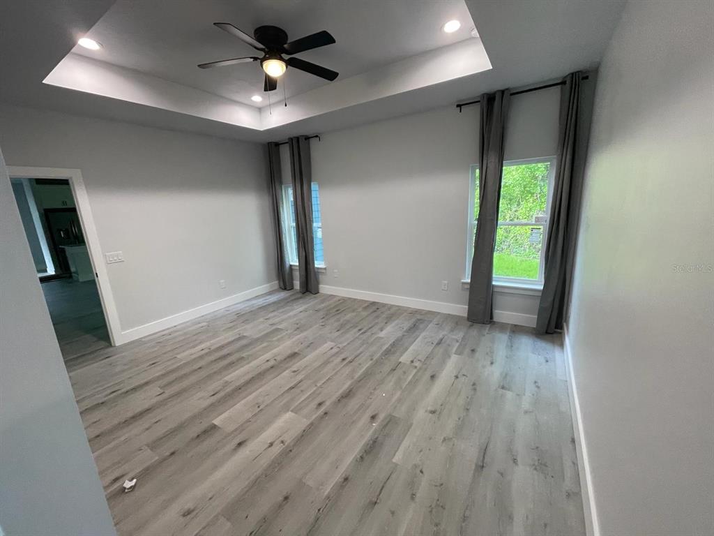 4102 Northwest 26th Drive Gainesville, FL 32605 - Photo 4 of 11 wooden floor in an empty room with a window