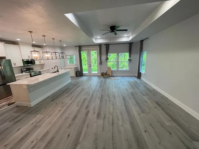 a large room with wooden floor and windows