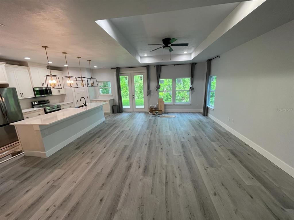 4102 Northwest 26th Drive Gainesville, FL 32605 - Photo 9 of 11 a large room with wooden floor and windows