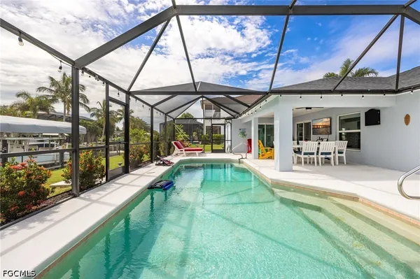 a view of swimming pool with a patio and a yard