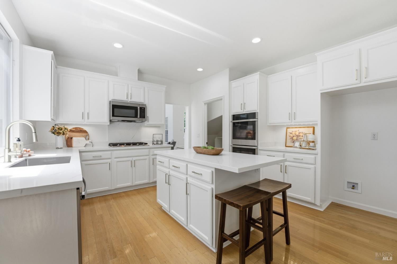 5148 Renaissance Court Fairfield, CA 94534 - Photo 18 of 79 a kitchen with white cabinets stainless steel appliances and sink